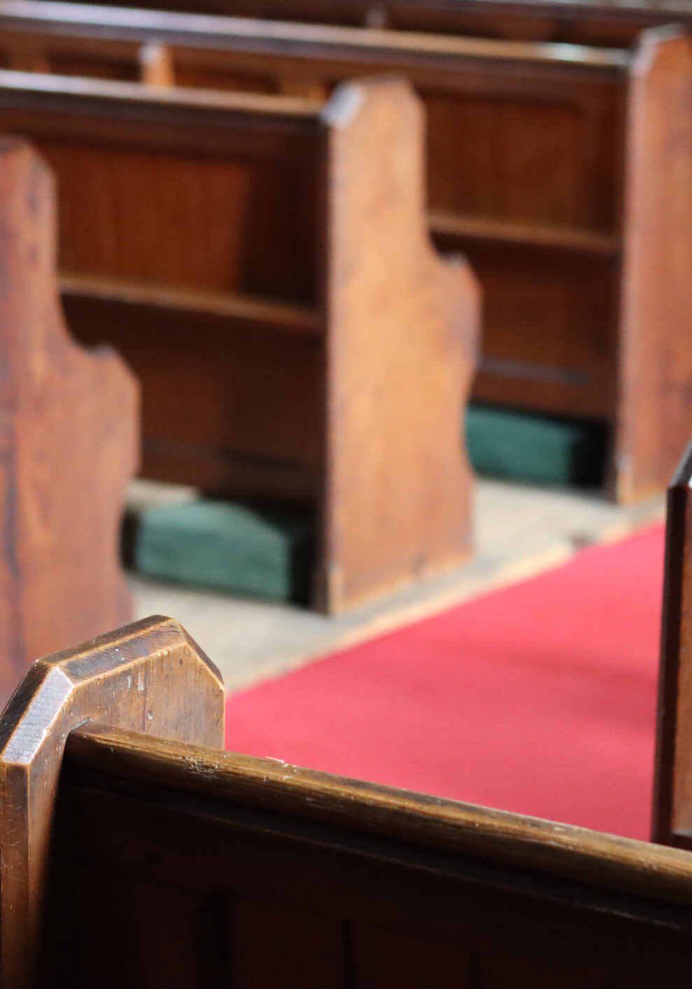 Rows of traditional wooden church pews